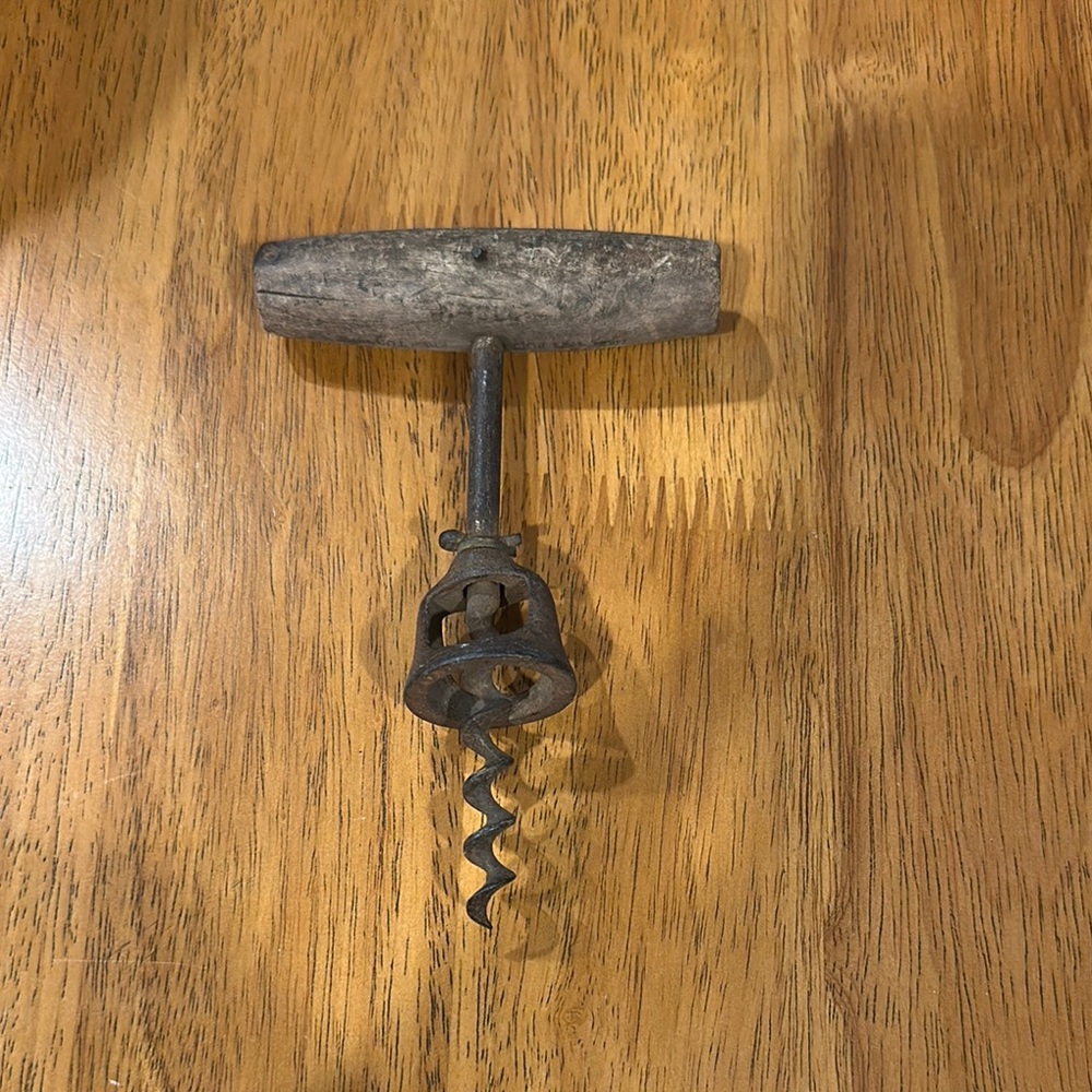Antique corkscrew for bar decoration. Wood handle. Corkscrew is rusty